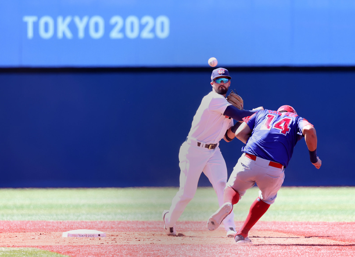 Eddy Alvarez throws to first base against the Dominican Republic during the Tokyo Olympics.