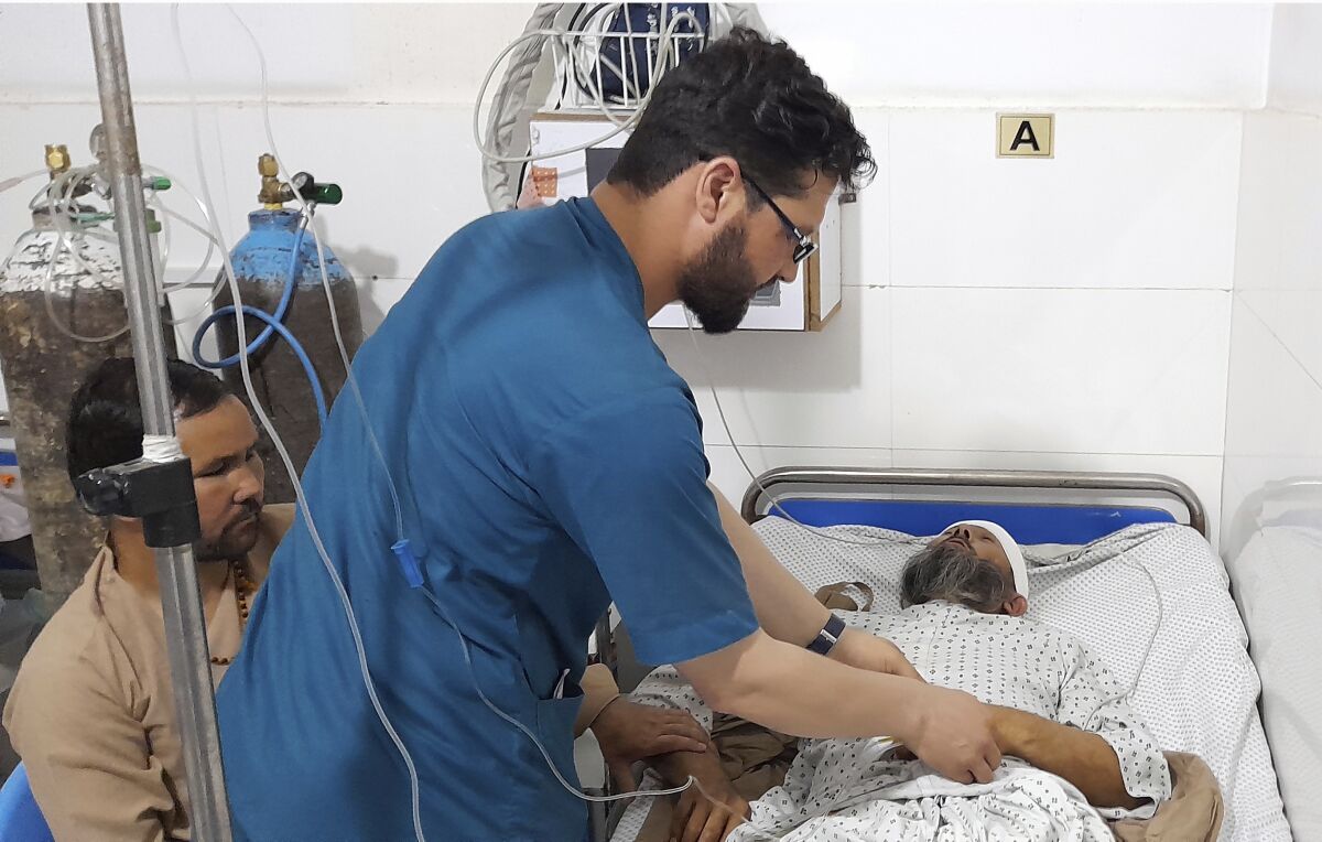 Medical workers treat a man in a hospital