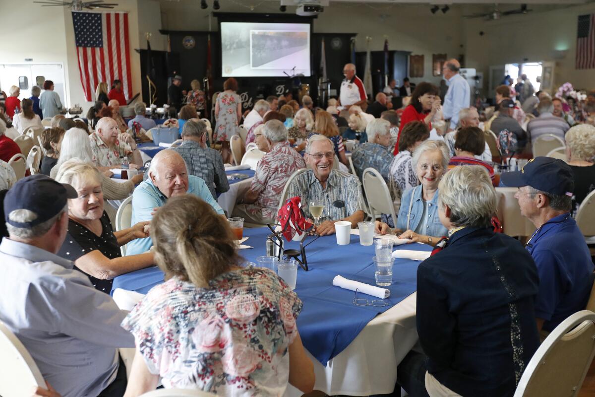 World War II and Korean War veterans reminisce during a luncheon and dance at American Legion Post 291 in Newport Beach on Thursday.