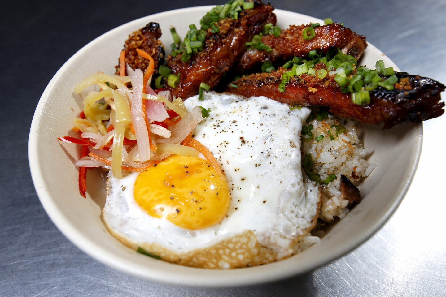 The Pinoy BBQ at Sari Sari Store in Grand Central Market features garlic pork ribs, garlic rice, apsara and fried egg.