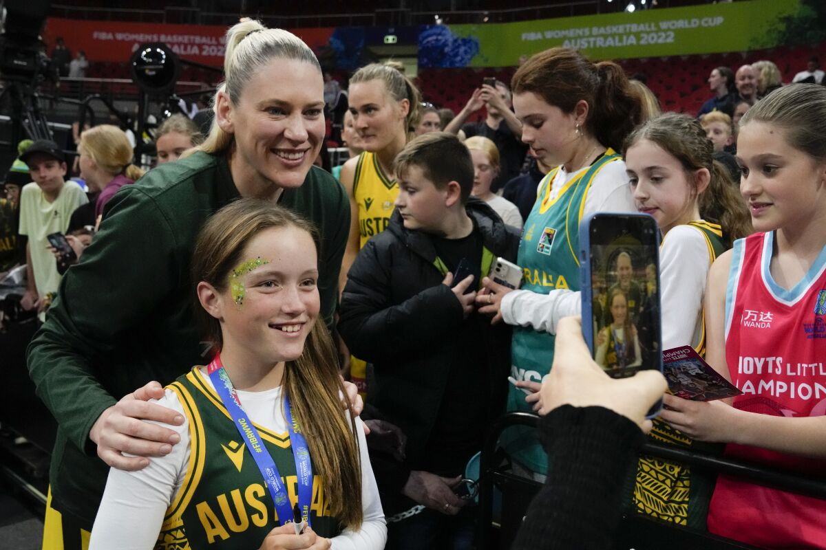 Australia's Lauren Jackson poses for a selfie with a young fan following their win over Japan at the women's Basketball World Cup in Sydney, Australia, Tuesday, Sept. 27, 2022. (AP Photo/Mark Baker)