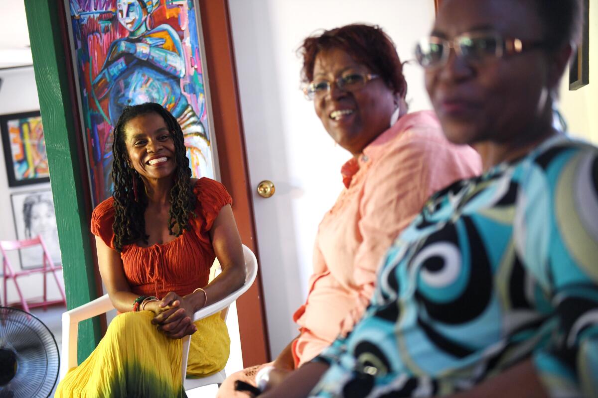 From left: Elizabeth Robinson, 57, Theresa Jeter, 60, and Esi Mathis, 63, chat during a gathering with the Essie Justice Group at St. Elmo Village in Los Angeles.