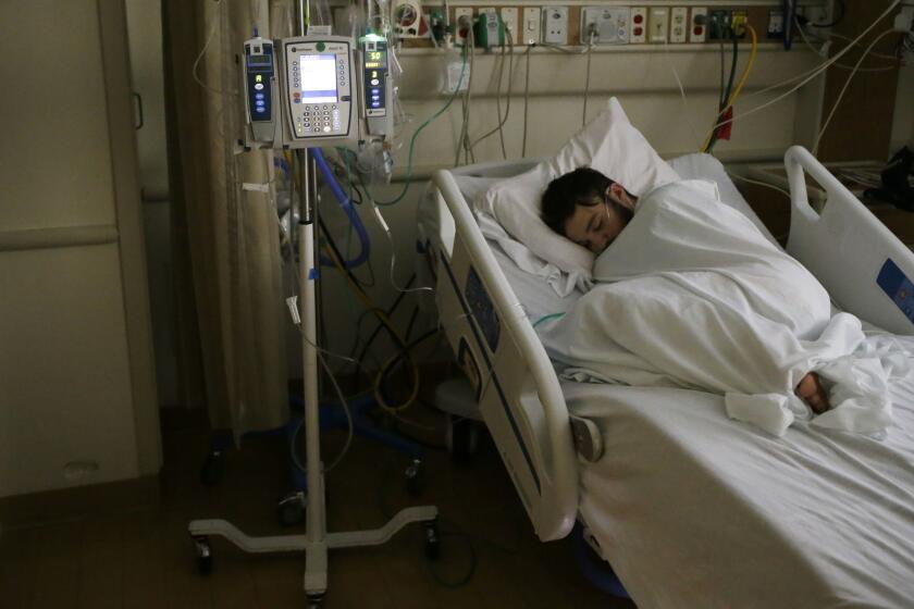 18-year-old Adam Hergenreder sleeps in his room in the intensive care unit on Wednesday, Sept. 4, 2019 at Advocate Condell Medical Center in Libertyville. Hergenreder was admitted to the hospital on Saturday with "vaping-induced acute lung injury" according to Dr. Stephen Amesbury, a pulmonary and critical care doctor at the hospital. (Stacey Wescott/Chicago Tribune)