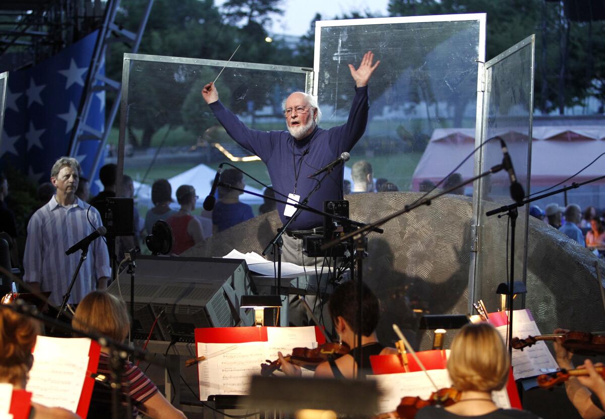 John Williams conducts the National Symphony Orchestra and other musicians for the upcoming debut of a new arrangement of the national anthem.