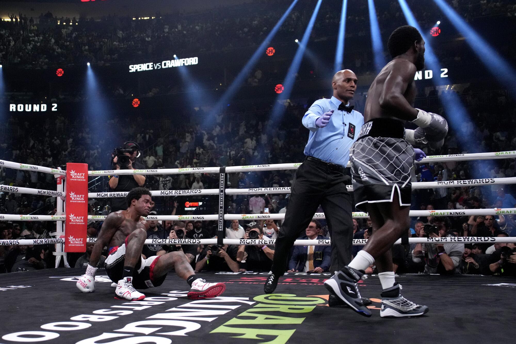 Errol Spence Jr., left, falls while fighting Terence Crawford.
