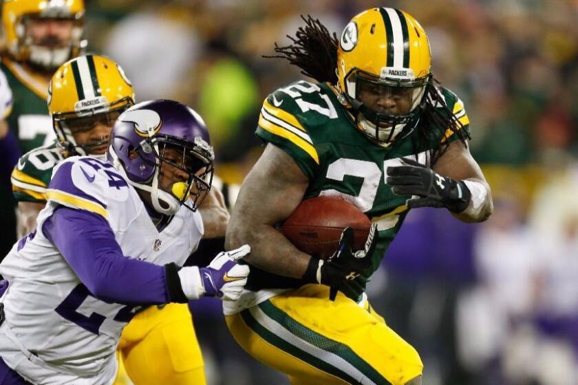 Vikings defensive back Captain Munnerlyn (24)attempts to tackle Packer running back Eddie Lacy (27)during a game at Lambeau Field on Jan. 3.