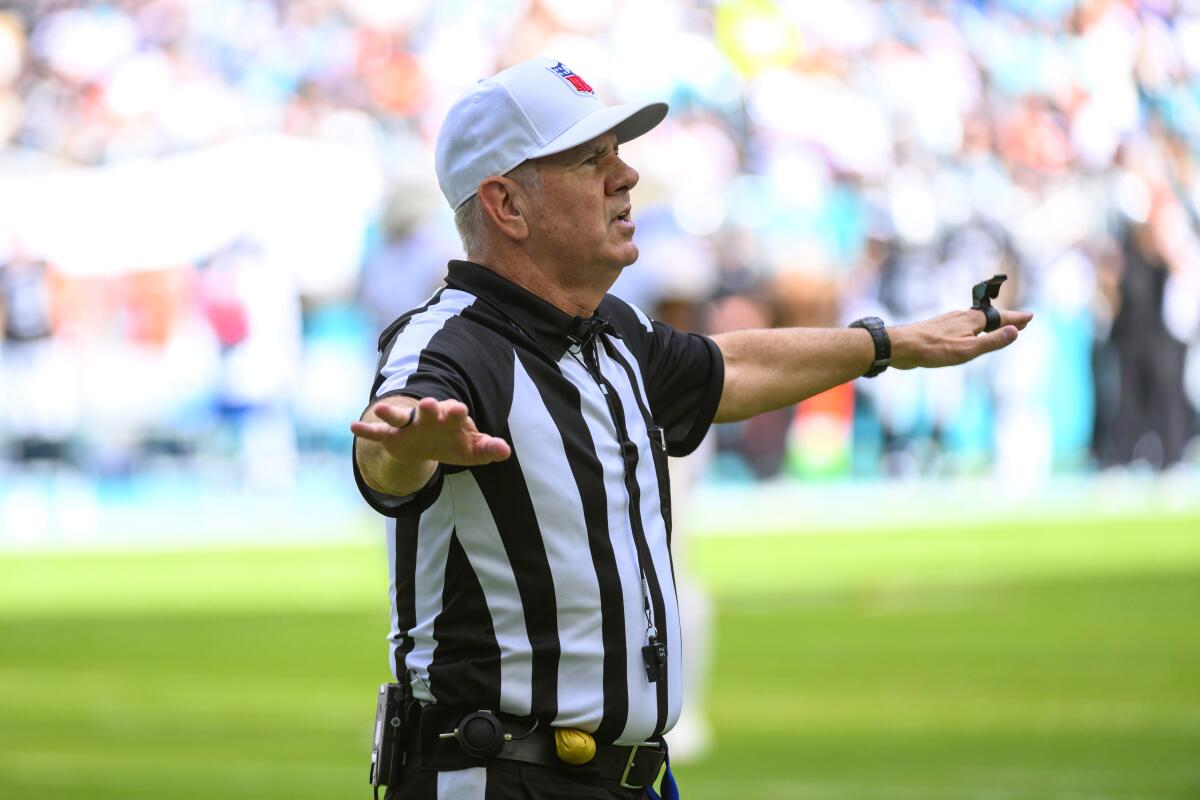 NFL referee Bill Vinovich makes a call during a game between the Las Vegas Raiders and Miami Dolphins.