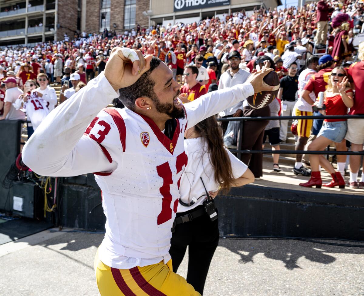 USC quarterback Caleb Williams celebrates and acknowledges Trojans fans during a 48-41 victory over Colorado.