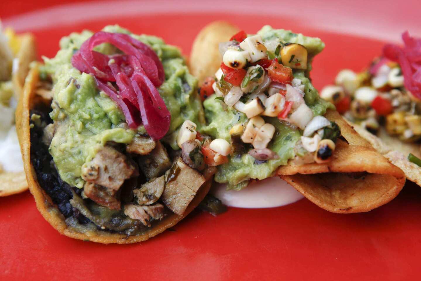 The tacos are loaded with fresh ingredients, including guacamole, roasted corn salsa and black beans.