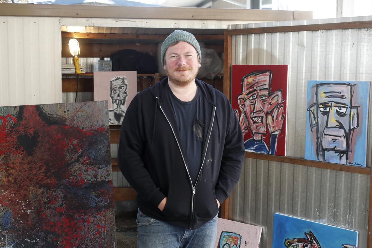 Artist Anthony Pedersen, who goes by the name Octopus/Caveman, in front of his painting shed in his Westminster home.