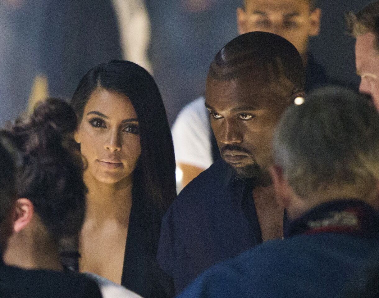 Kim Kardashian and Kanye West arrive at the presentation of Lanvin's spring/summer 2015 ready-to-wear fashion collection at Paris Fashion Week.