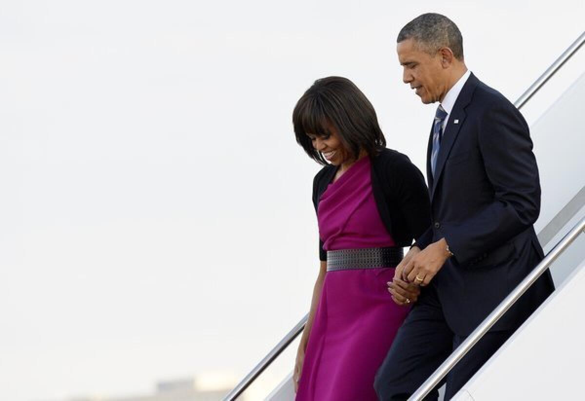President Obama and First Lady Michelle Obama arrive at Love Field in Dallas on Wednesday.