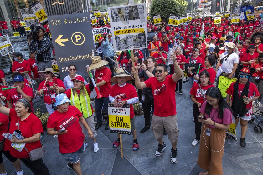 LOS ANGELES, CA-AUGUST 7, 2023:Striking hotel workers protest outside the InterContinental Los Angeles Downtown hotel, at the intersection of 7th St. and Figueroa in downtown Los Angeles. The union has filed a formal complaint after a series of violent incidents involving security at three hotels in L.A. and Orange. counties. (Mel Melcon / Los Angeles Times)