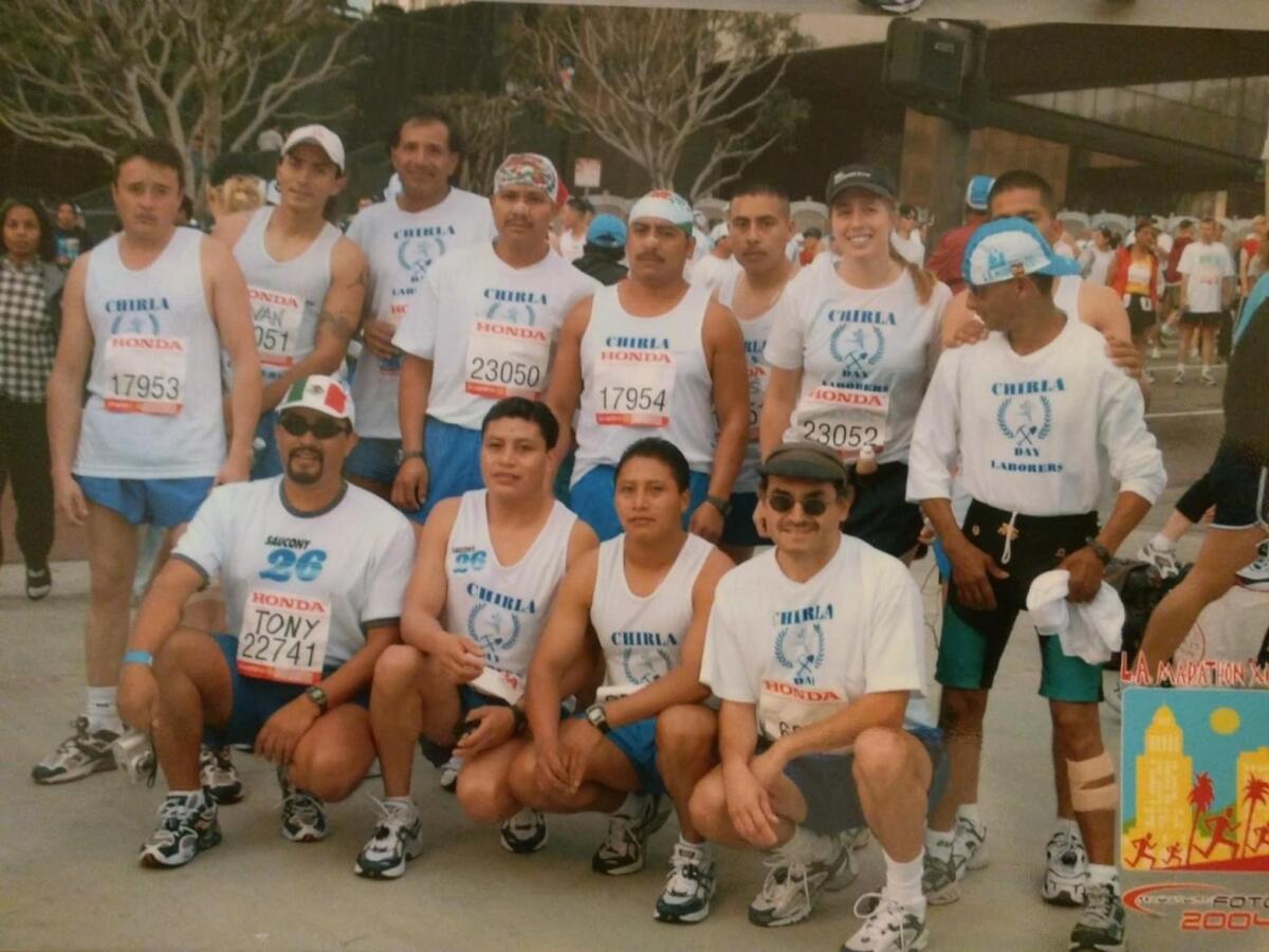 A group of runners pose for a photo.
