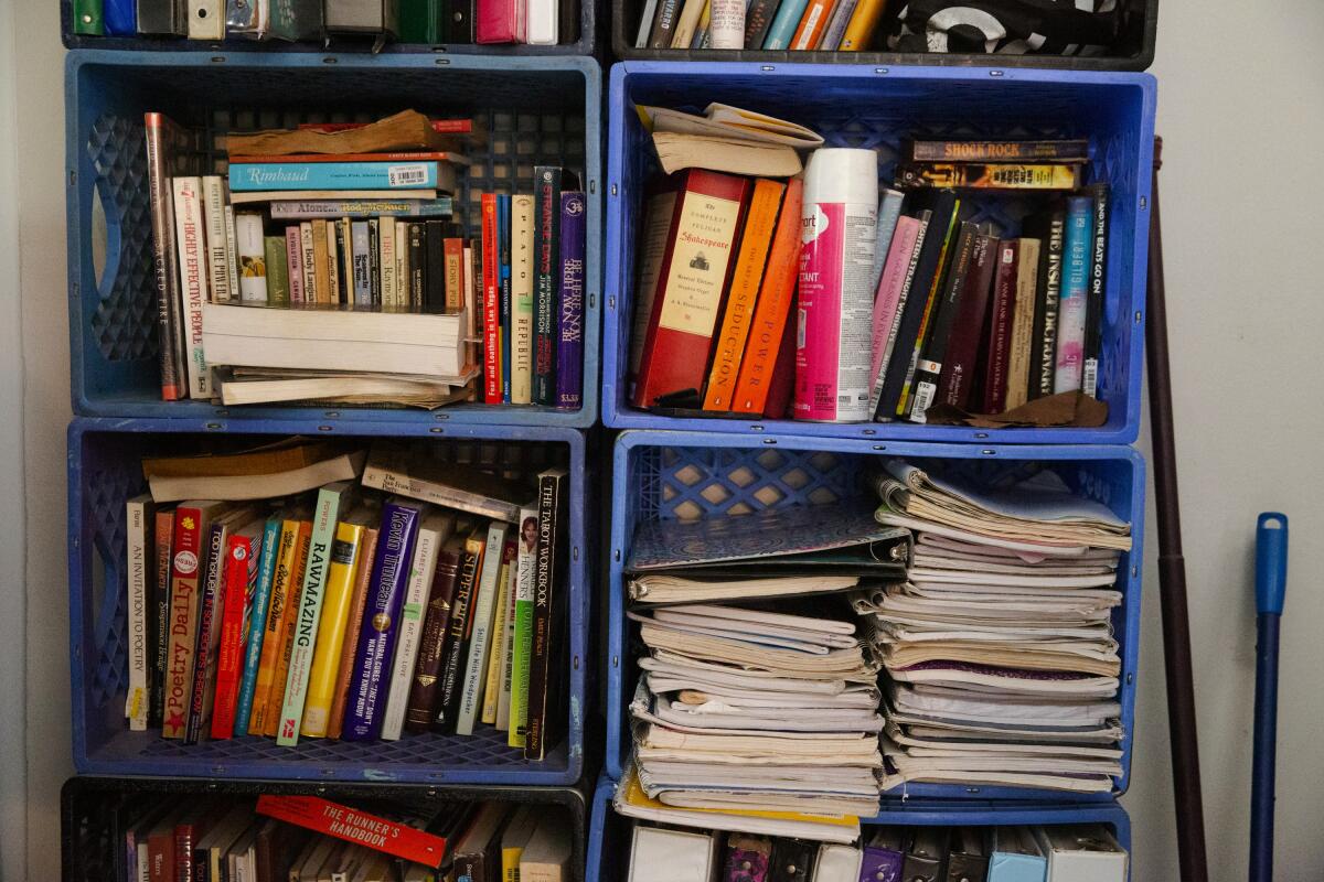 Plastic boxes from dumpsters turned into bookshelves.