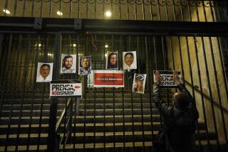 A person posts photos of slain journalists during a vigil to protest the murder of journalist Heber Lopez, on the gate of Mexico's Attorney General's office in Mexico City, Monday, Feb. 14, 2022. Lopez, who was the director of the online news site Noticias Web, was shot to death Thursday, Feb. 10, in the coastal city of Salina Cruz, in Oaxaca state. The Committee to Protect Journalists declared these six past weeks the "deadliest for the Mexican press in over a decade." (AP Photo/Eduardo Verdugo)