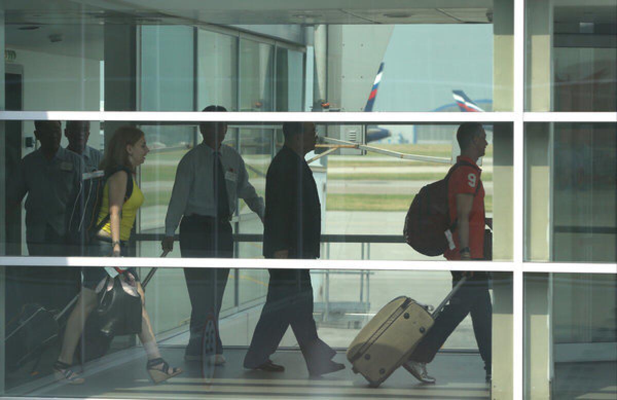 Passengers walk to board Aeroflot flight SU150 from Moscow to Havana at Sheremetyevo airport in Moscow. There was no sign of National Security Agency leaker Edward Snowden, who is believed to be at the transit zone of the airport.