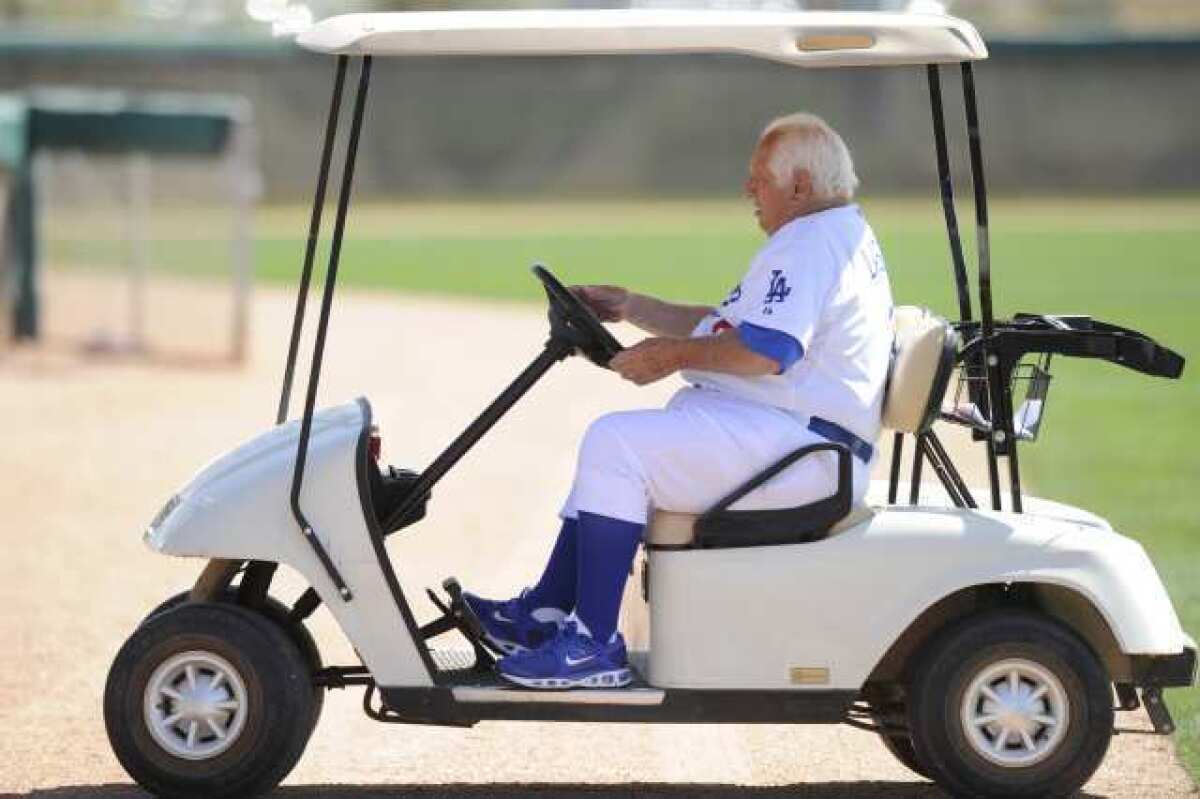Tommy Lasorda drives a golf cart around the Dodgers' spring training facility at Camelback Ranch.