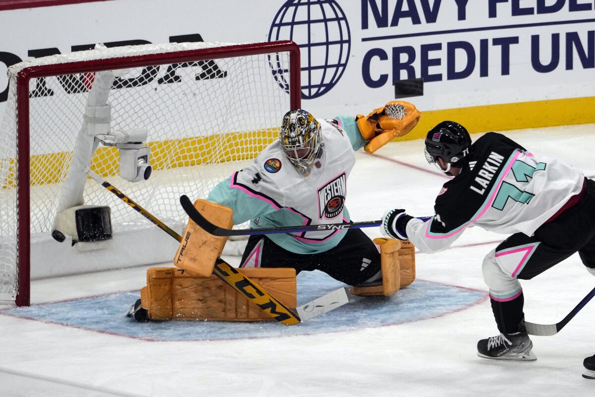 The Atlantic Division's Dylan Larkin scores past Central Division goalie Juuse Saros during the NHL All-Star Game final.