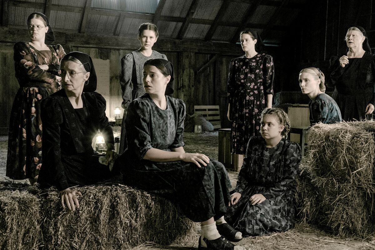 Women gather in a barn to discuss critical matters in a scene from "Women Talking."
