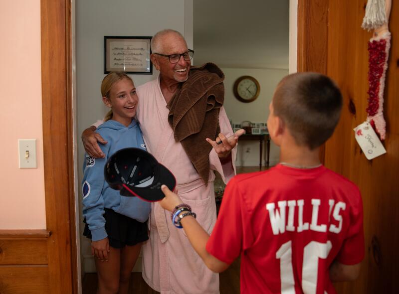 Scott Picker talks with his grandchildren Bailey Willis and Brandt Willis at home.