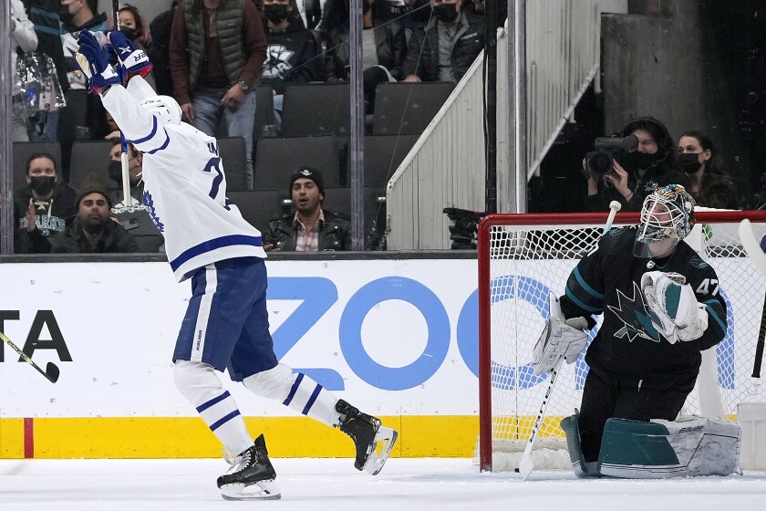 Toronto Maple Leafs right wing Wayne Simmonds (24) celebrates a goal against San Jose Sharks goaltender James Reimer, right, during the first period of an NHL hockey game Friday, Nov. 26, 2021, in San Jose, Calif. (AP Photo/Tony Avelar)