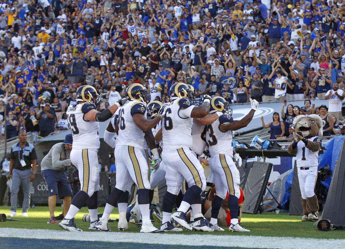 Rams playersgather on the sideline and salute the fans before their preseason game against the Cowboys.