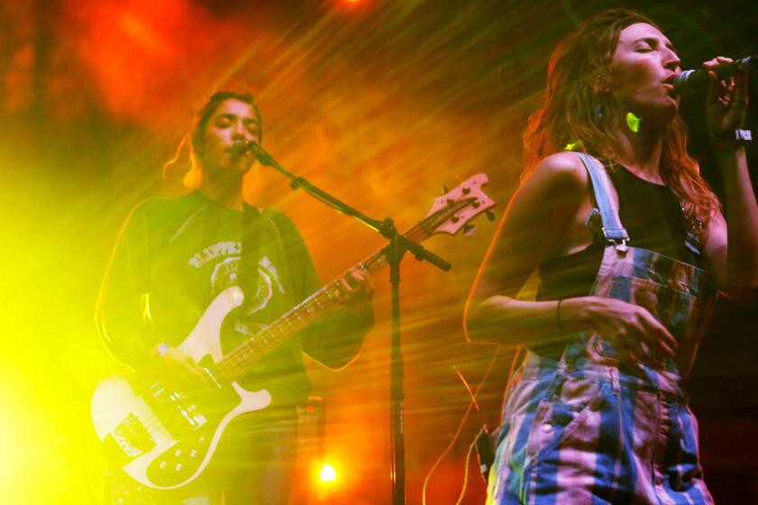 Jenny Lee Lindberg, left, and Emily Kokal of Warpaint perform on the second night of Long Beach's Music Tastes Good festival.