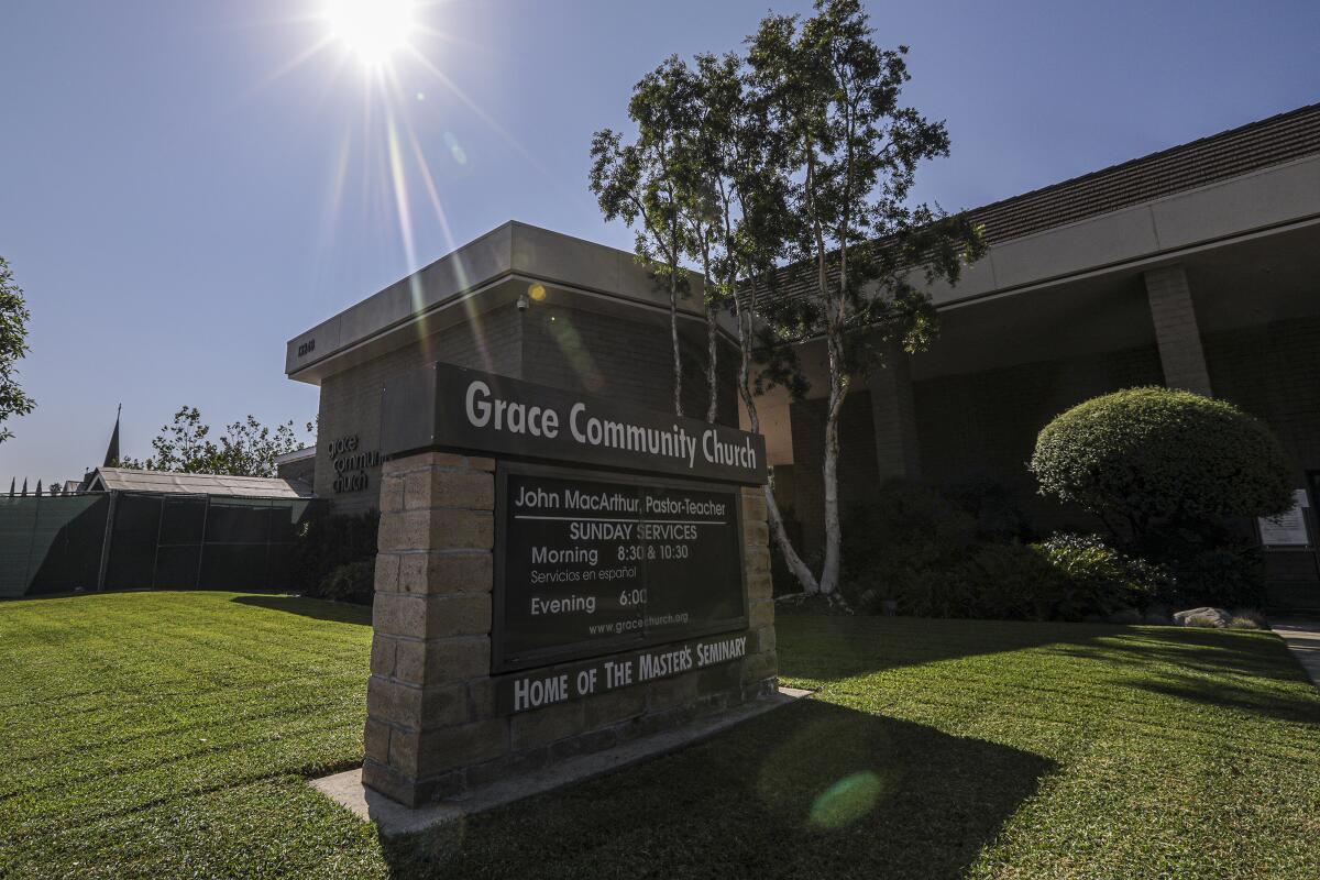 A brown brick sign on the front lawn of Grace Community Church