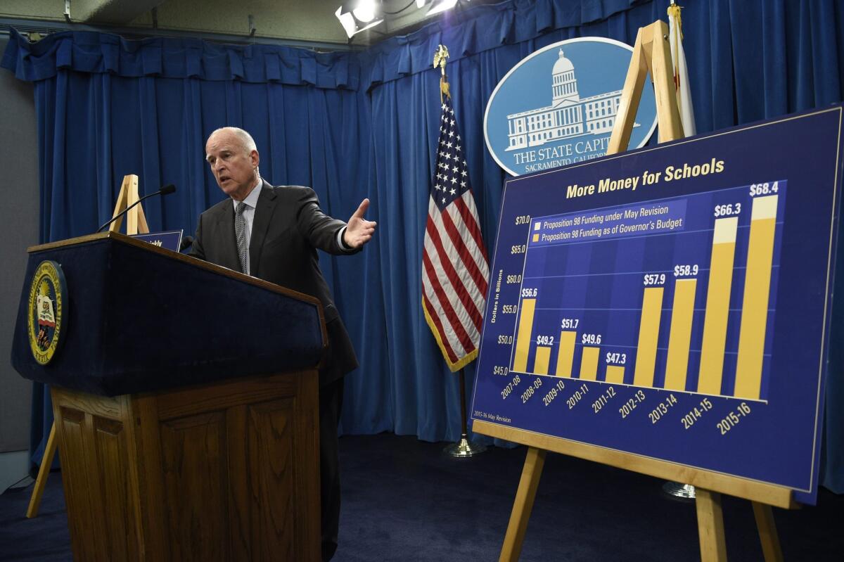Gov. Jerry Brown unveils his revised 2015-16 California budget proposal Thursday at the Capitol in Sacramento.
