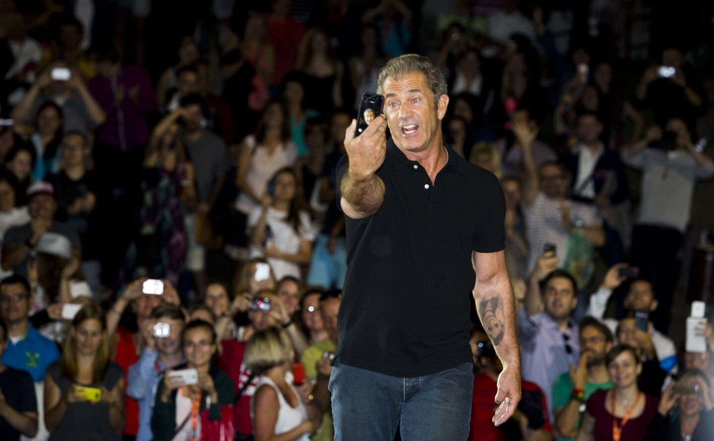 Actor Mel Gibson takes a selfie at an outdoor screening of "Mad Max" during the 49th Karlovy Vary International Film Festival on July 4, 2014, in Karlovy Vary, Czech Republic.