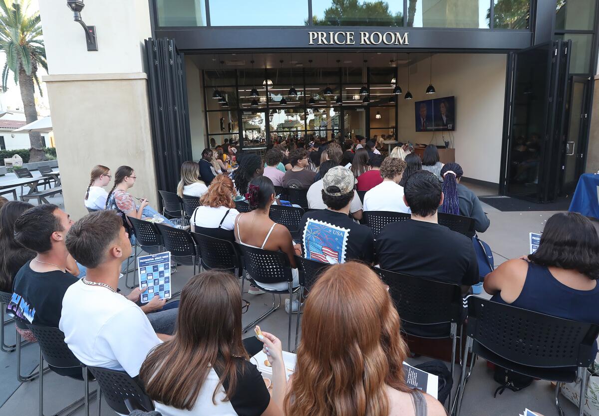 Vanguard University students listen carefully during a presidential debate watch party on campus on Tuesday night.