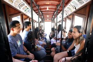 LOS ANGELES-CA-JULY 19, 2024: Participants in The American Exchange Project, a program that sends graduating high school seniors from all over the country to states unlike their own for one week to learn all about that new place and the people in it, ride Angels Flight Railway during a tour of Downtown Los Angeles on July 19, 2024. (Christina House / Los Angeles Times)