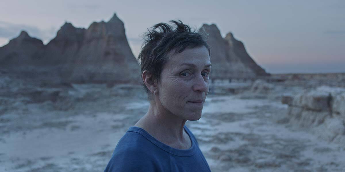 Frances McDormand against a backdrop of craggy rocks.
