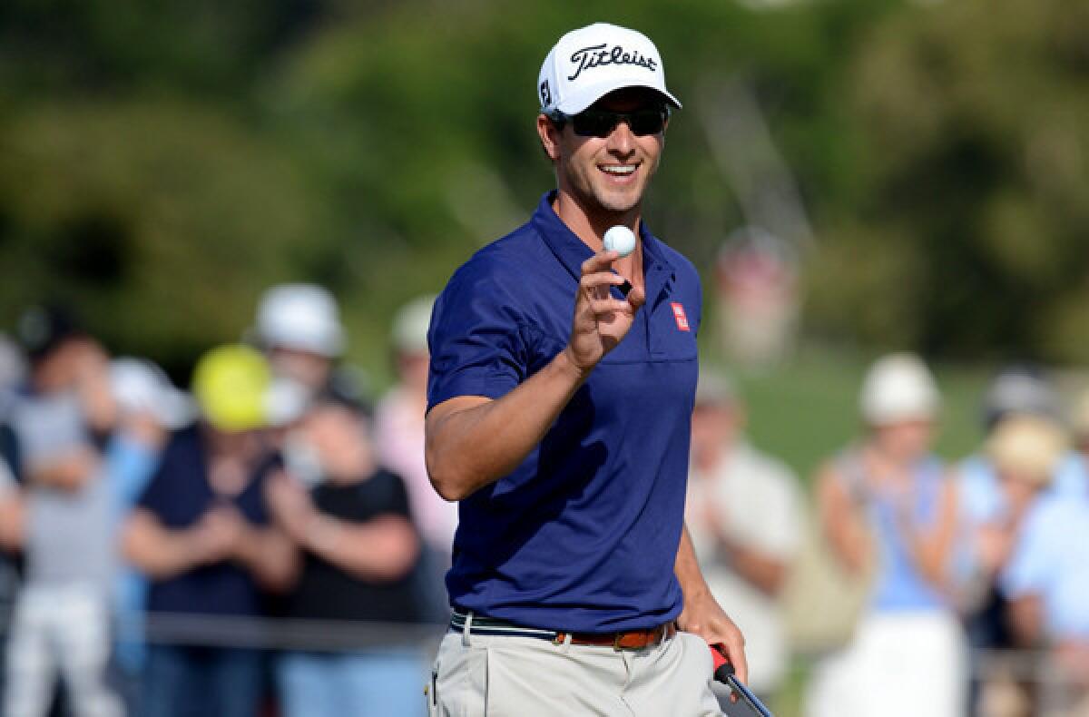 Adam Scott acknowledges the crowd after making a putt during the first round of the Australian Open on Thursday at the Royal Sydney Golf Club in Sydney.