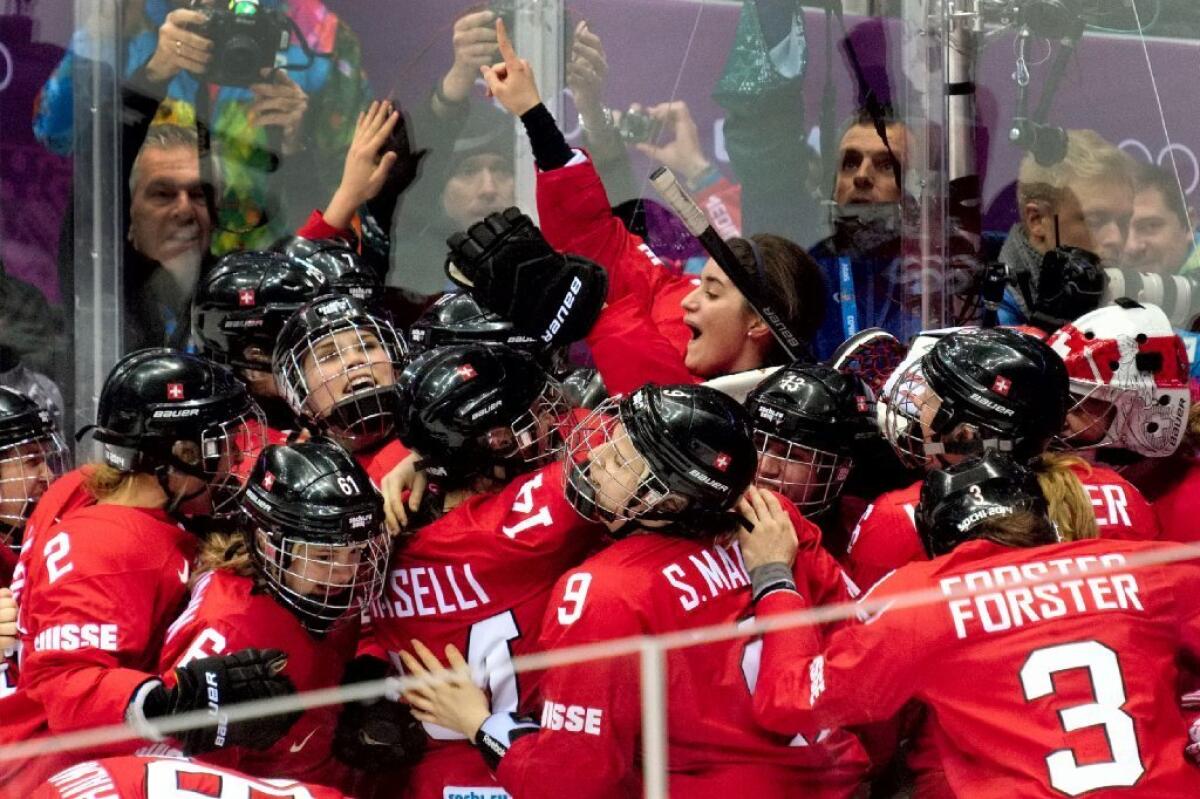 Switzerland's women's hockey team celebrates its bronze medal.