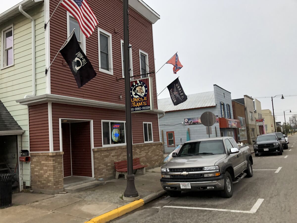 A Confederate flag waves above the entrance to Uncle Sam's bar in Arcadia, Wisconsin