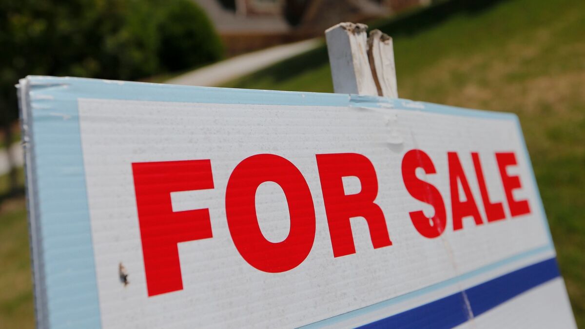 A sign advertises a home for sale.
