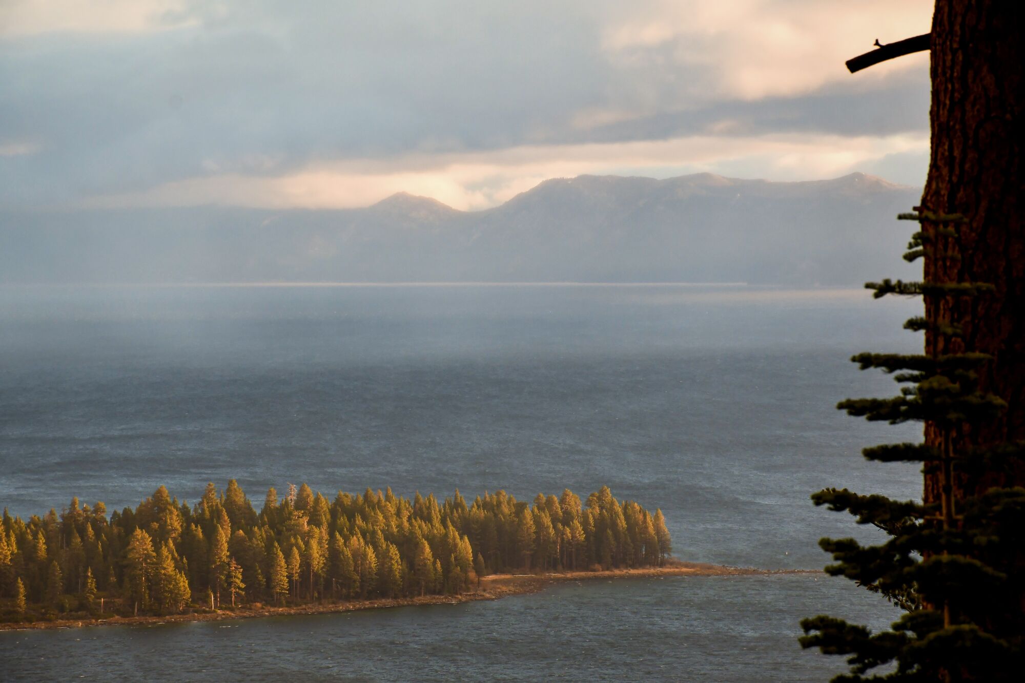 Sunrise over Lake Tahoe's Emerald Bay sometimes comes with billowing clouds and rainbows.