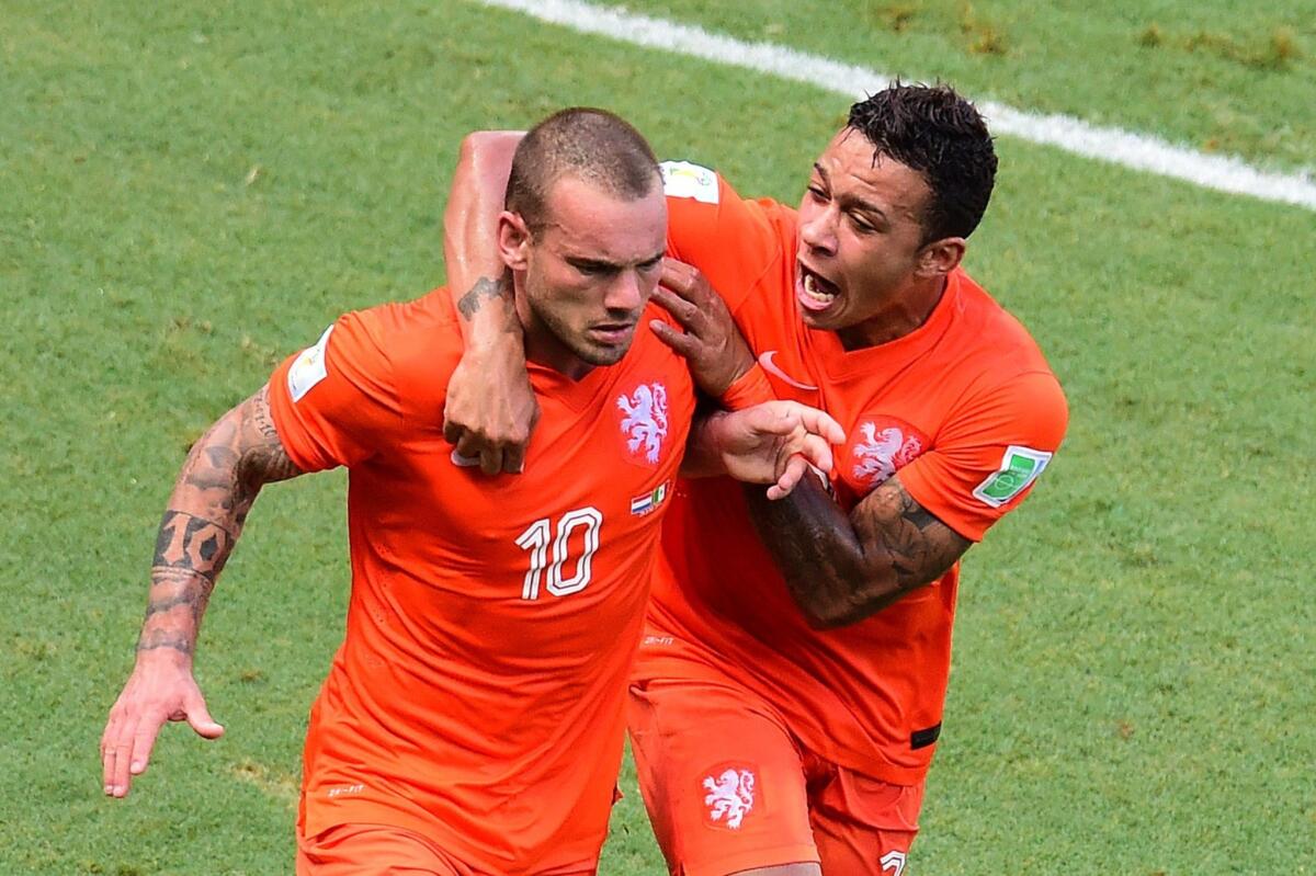 Wesley Sneijder, left, reacts after scoring the game-tying goal in the 88th minute for the Netherlands. The Netherlands defeated Mexico, 2-1, with a goal in extra time to advance to the quarterfinal round of the World Cup.