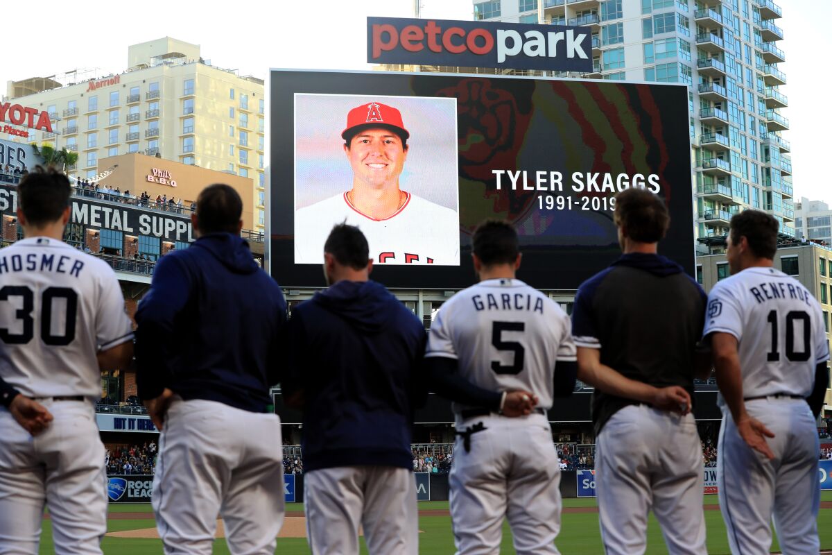 Players for the San Diego Padres and San Francisco Giants stand during a moment of silence for pitcher Tyler Skaggs of the Los Angeles Angels of Anaheim at PETCO Park on July 01, 2019 in San Diego, California. Skaggs passed away in his hotel room earlier in the day in Texas.