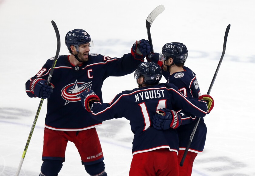 Columbus Blue Jackets forward Boone Jenner, left, celebrates with forward Gustav Nyquist, center, and forward Sean Kuraly after Kuraly's goal against the New York Rangers during the third period of an NHL hockey game in Columbus, Ohio, Thursday, Jan. 27, 2022. The Blue Jackets won 5-3. (AP Photo/Paul Vernon)