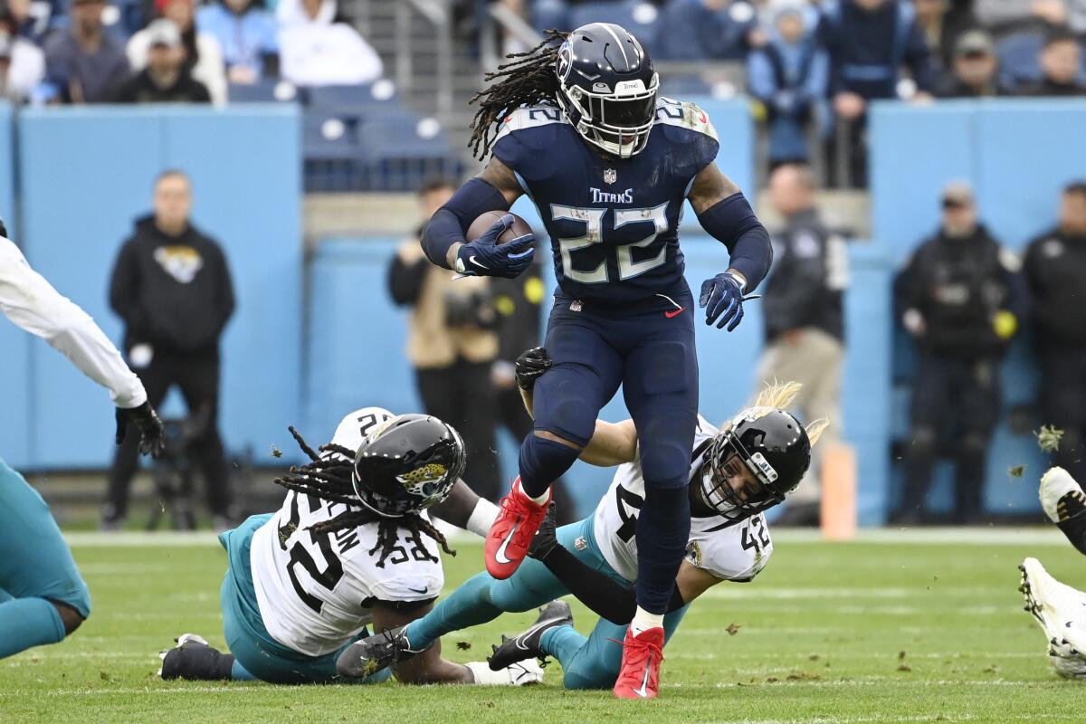 Tennessee Titans running back Derrick Henry carries the ball against the Jacksonville Jaguars on Dec. 11, 2022.