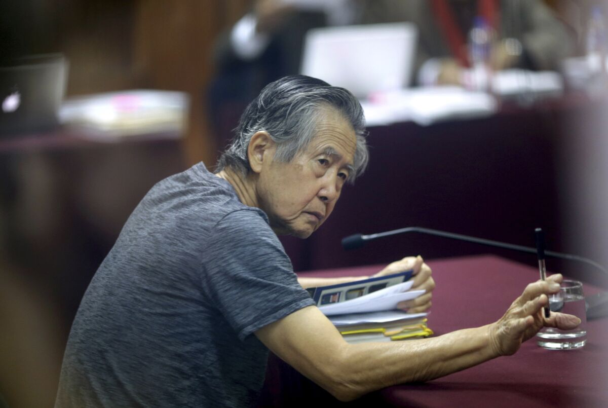 Jailed former Peruvian President Alberto Fujimori attends his 2014 trial in Lima, Peru.