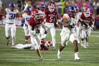 Costa Mesa, CA - August 19: Orange Lutheran strong safety Wes Barksdale, left, can't catch Gardena Serra running back Cincere Rhaney as he runs in a touchdown in the third quarter of the high school football opener at Lebard Stadium in Costa Mesa on Friday, Aug. 19, 2022. (Allen J. Schaben / Los Angeles Times)