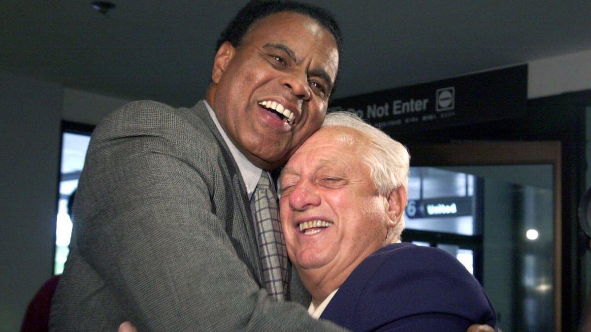 Dodgers vice president of external affairs Tommy Hawkins, left, greets former Dodgers manger Tommy Lasorda at Los Angeles International Airport in September 2000.