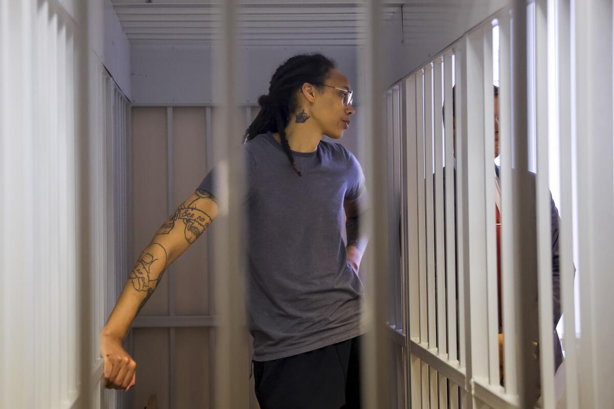 WNBA star Brittney Griner listens to the verdict standing in a cage in a courtroom outside Moscow, Russia, on Aug. 4.