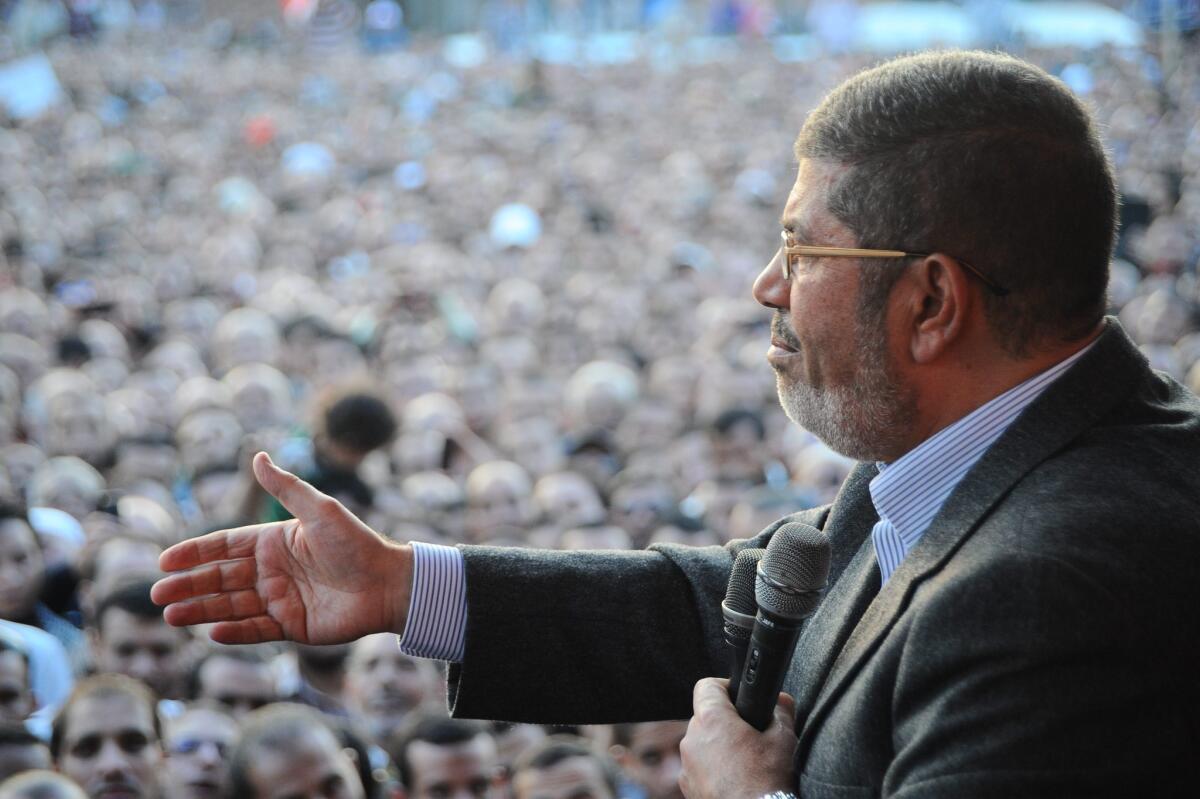 Egyptian President Mohamed Morsi speaks to his supporters next the Presidential palace in Cairo.