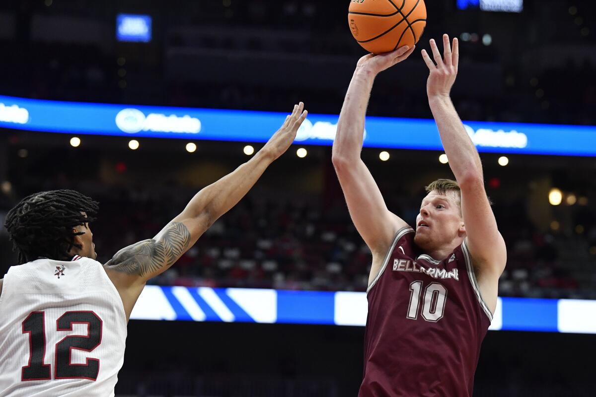 Bellarmine guard Garrett Tipton (10) shoots over Louisville forward JJ Traynor (12) during the first half of an NCAA college basketball game in Louisville, Ky., Wednesday, Nov. 9, 2022. (AP Photo/Timothy D. Easley)