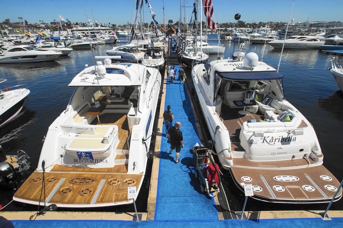 Guests look at boats during the the 37th annual Lido Boat Show in Newport Beach on Friday.